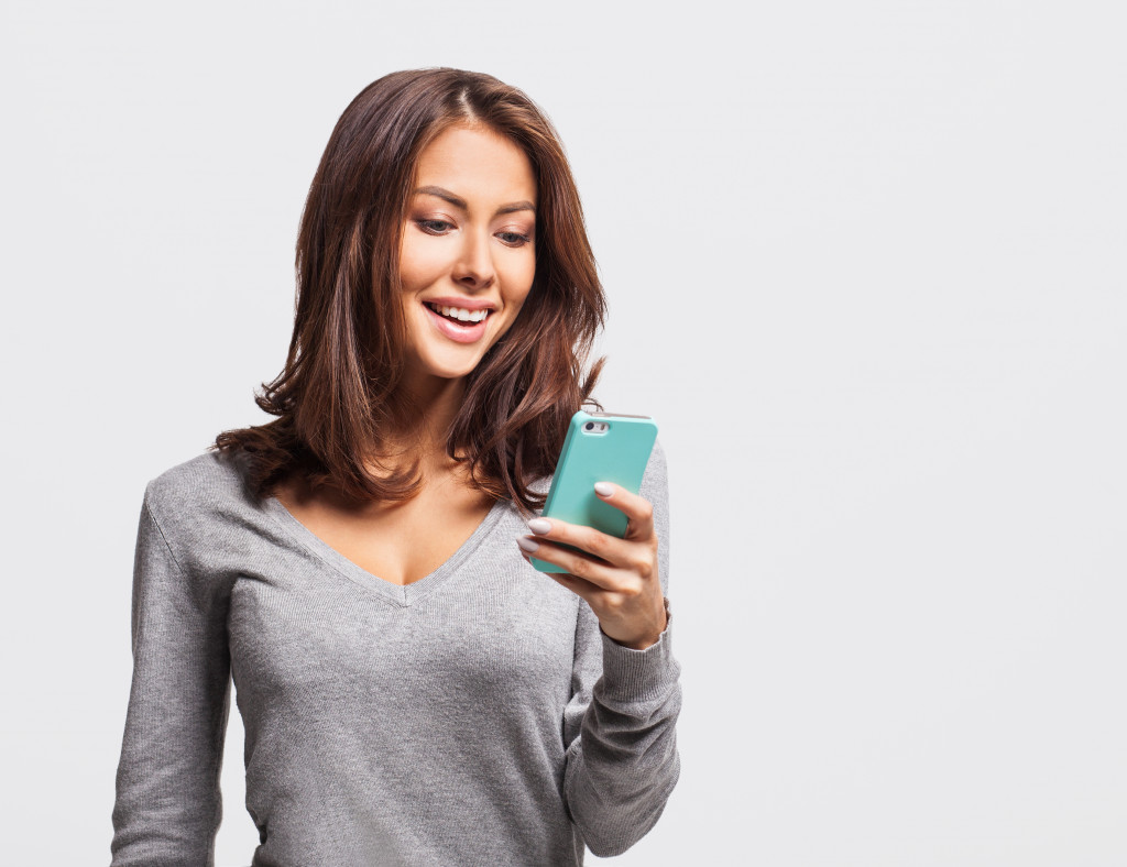 woman with a blue phone case