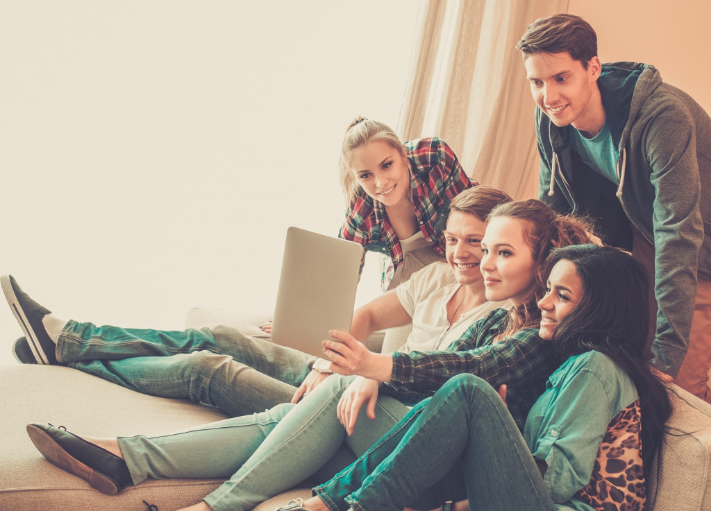 Teenagers checking social media together