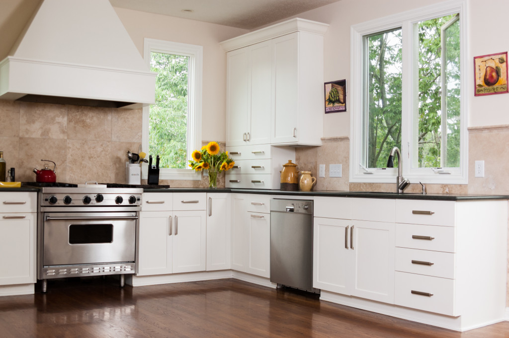 A kitchen with appliances and storage in neutral colors