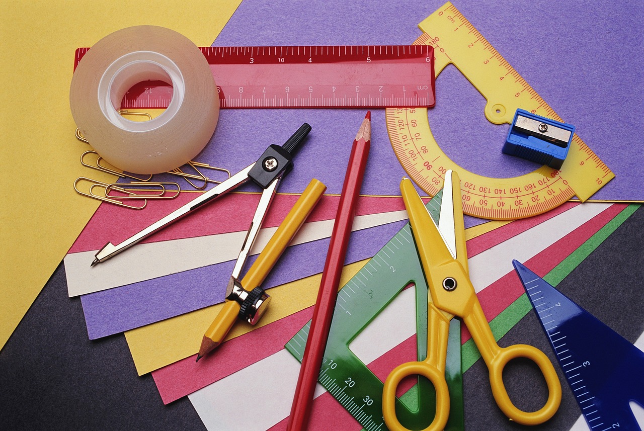 paper craft tools scissors ruler colored paper flat lay